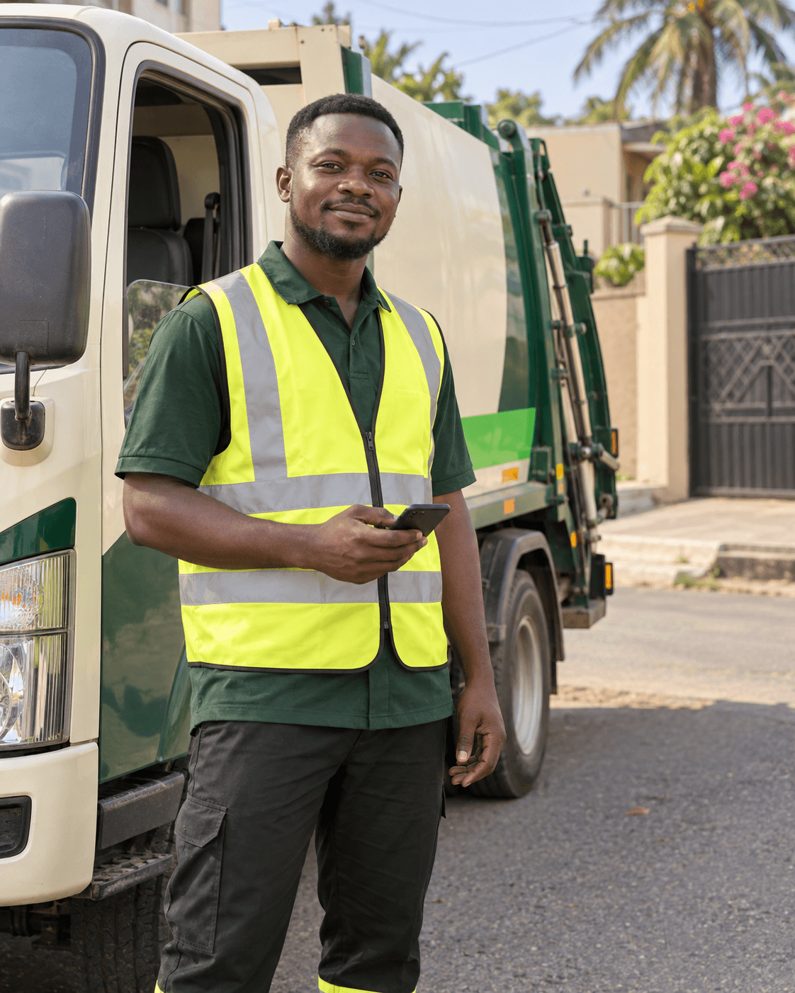 A Wastenify waste collector holding a phone beside a collection truck.